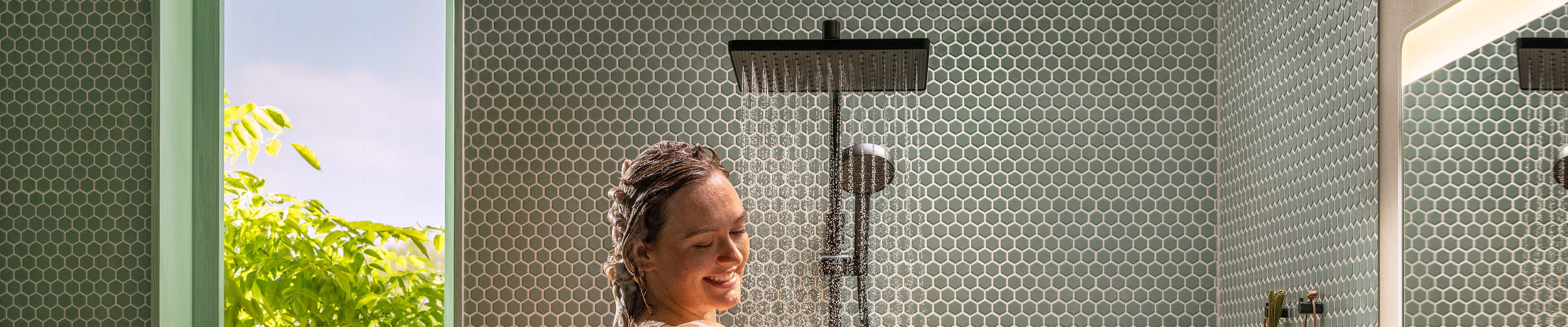 Woman is visibly impressed as she showers with the Activera Q shower pipe.