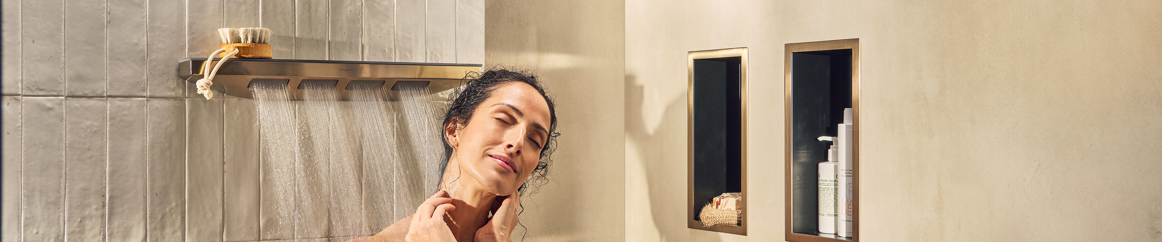Woman enjoying PowderRain under Rainfinity shoulder shower.