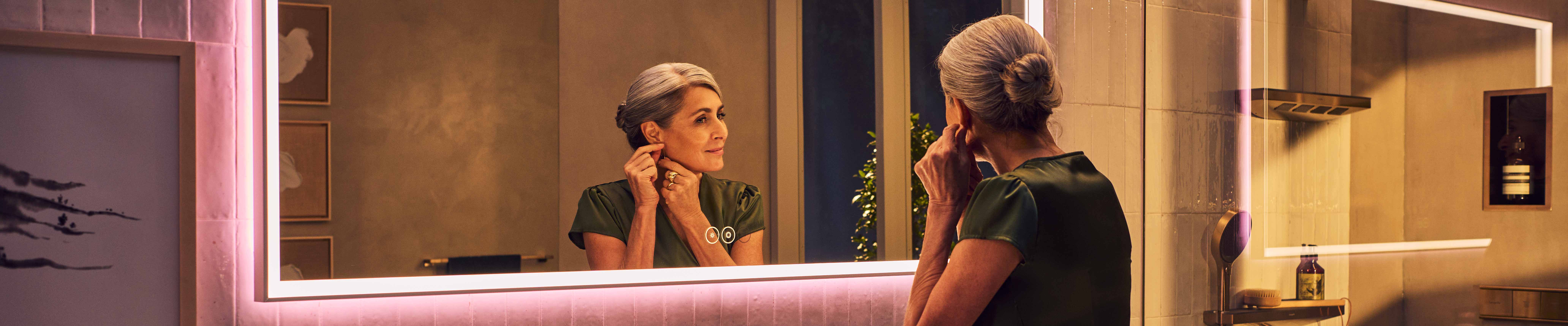 Xarita E mirror with woman at the vanity.