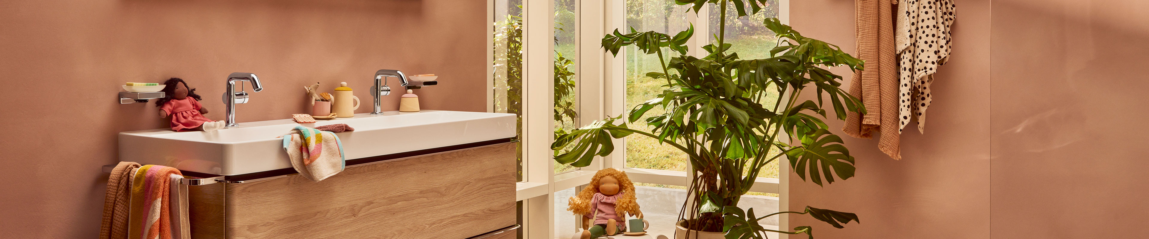 Two hansgrohe bathroom faucets on the long wash basin.